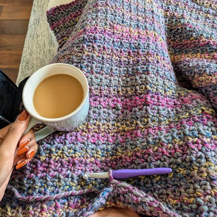 holding mug with cozy chunky blanket
