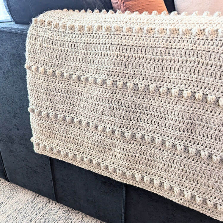 crochet bobble blanket on arm of couch